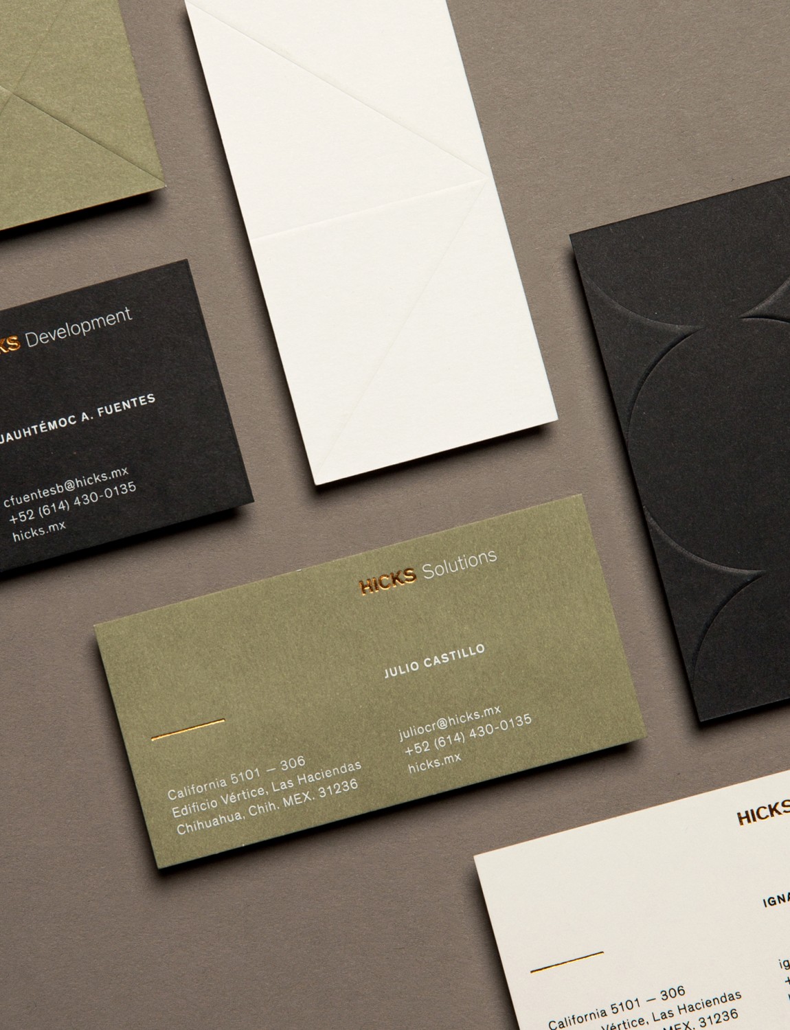 Brand identity and business cards with block foil and blind deboss detail designed by Face for Hicks Solutions.