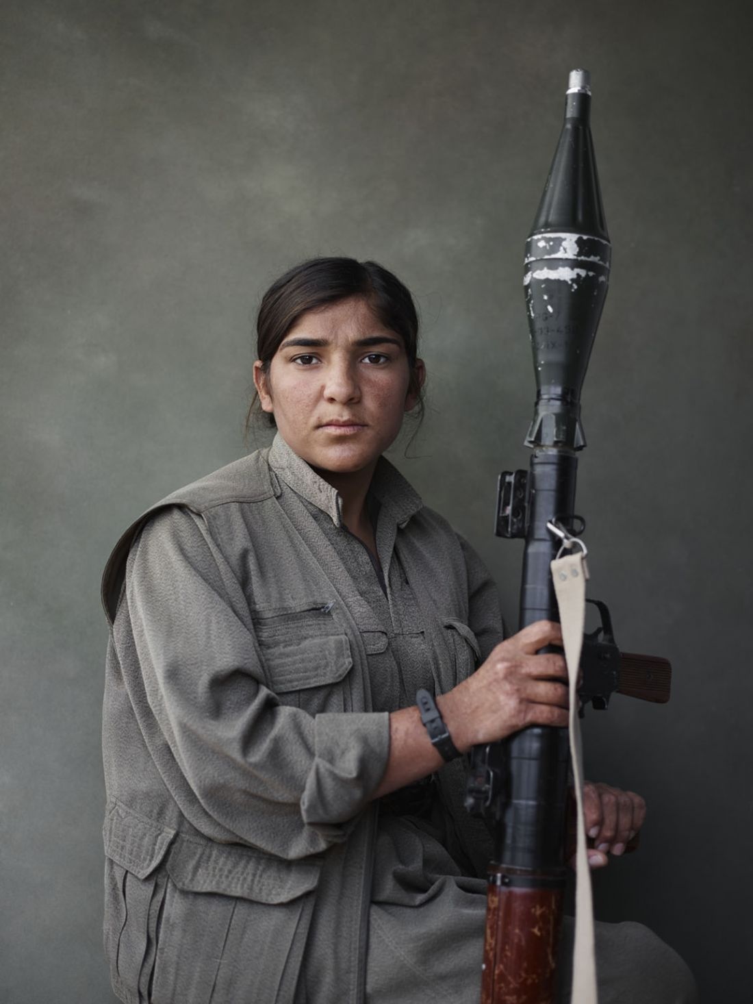 Portrait of Sarya with rocket-propelled grenade launcher. Makhmur, Erbil Governorate, Iraq, March 4, 2015. From [We Came From Fire?](?https://amzn.to/2L9l8Vm) by Joey L. – published by powerHouse Books