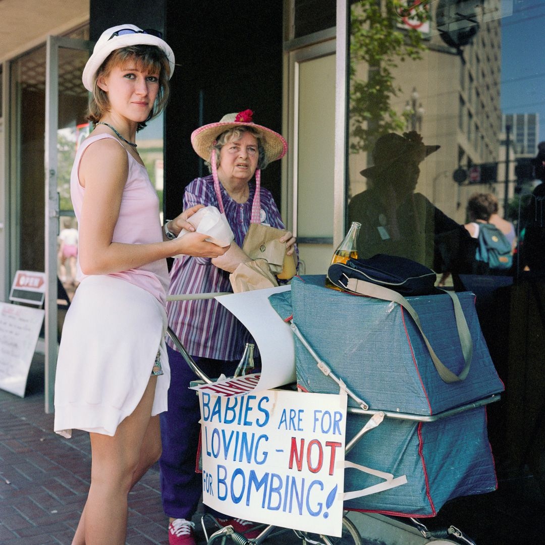 Mother and Daughter with Baby Carriage, at Peace, Jobs and Justice Parade 1986 ? Janet Delaney